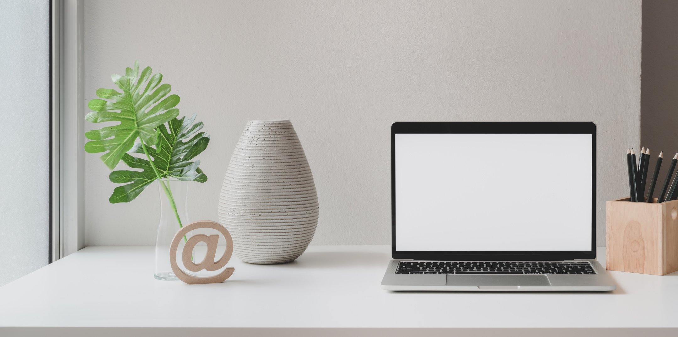 Laptop placed on white table in creative workplace